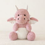 Dragon moelleux en peluche 30 cm rose sur fond crème, en studio
