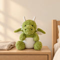 Dragon moelleux en peluche 30 cm vert posé sur une table de chevet en bois clair