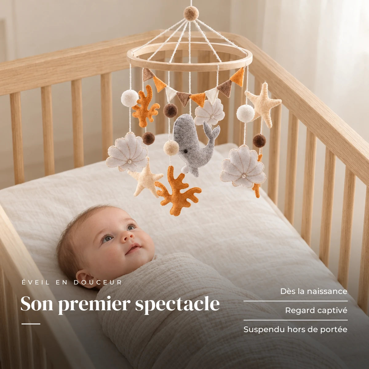 Bébé allongé dans son lit qui regarde le mobile bébé Corail en bois au-dessus de lui. Son premier spectacle : dès la naissance, regard captivé, suspendu hors de portée