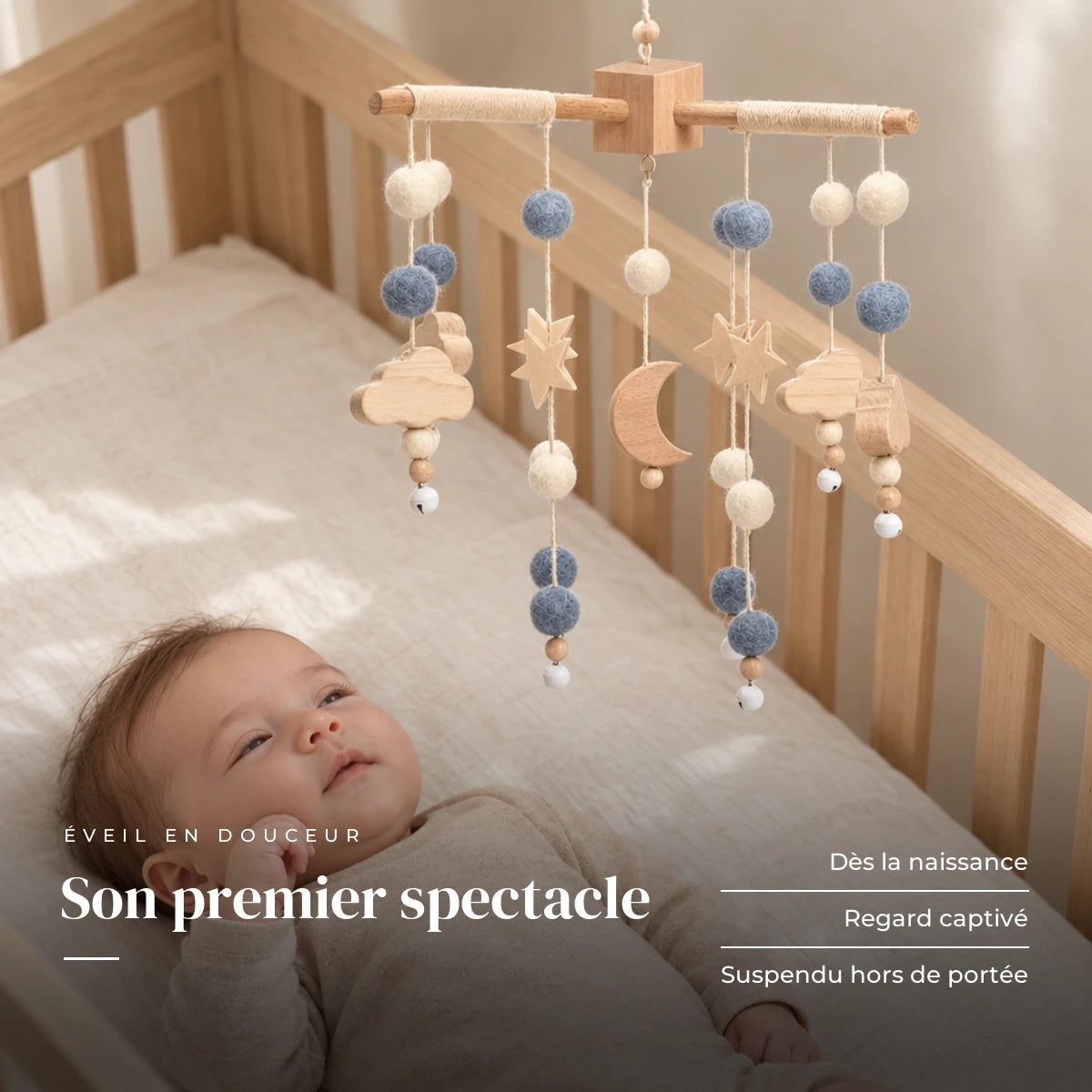 Bébé allongé dans son lit qui regarde le mobile bébé Lune en bois au-dessus de lui. Son premier spectacle : dès la naissance, regard captivé, suspendu hors de portée