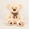 Ours en peluche bouclé traditionnel avec nœud rétro beige sur fond crème, en studio