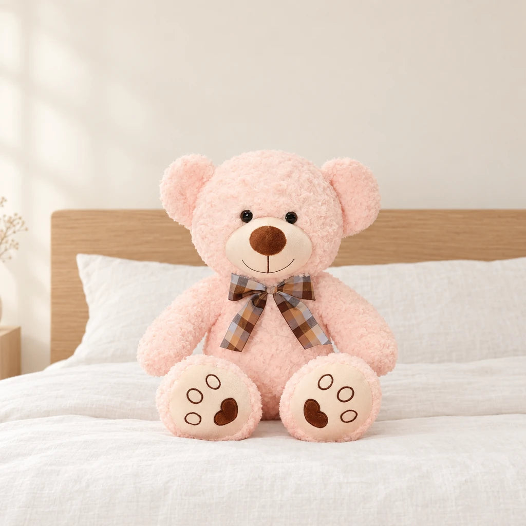 Ours en peluche bouclé traditionnel avec nœud rétro rose pâle posé sur un lit en lin blanc