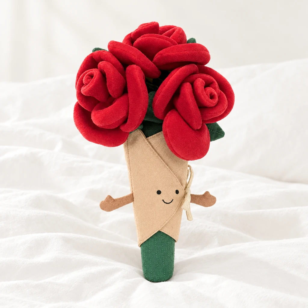 Peluche bouquet de roses rouges kawaii posée sur un lit blanc, en pleine lumière