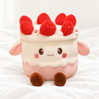 Peluche kawaii gâteau gourmand posée sur un lit blanc, en pleine lumière