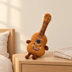 Peluche instrument kawaii guitare souriante posée sur une table de chevet en bois clair