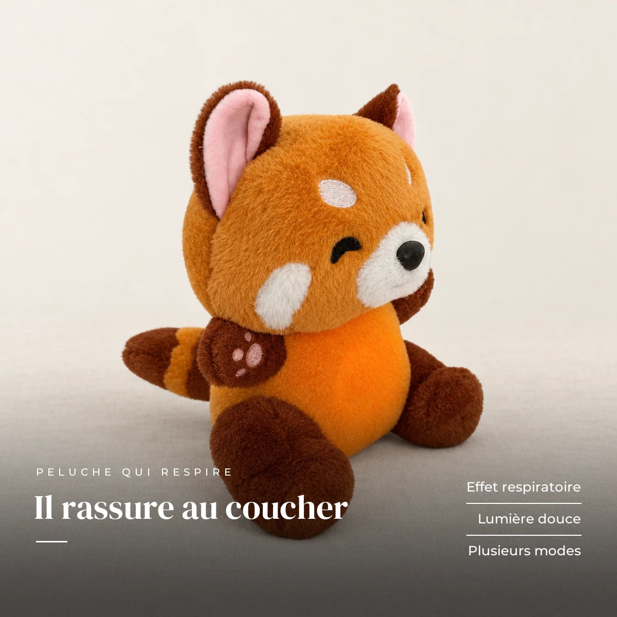 Peluche panda roux qui respire sur fond crème, en studio. Il rassure au coucher : effet respiratoire, lumière douce, plusieurs modes