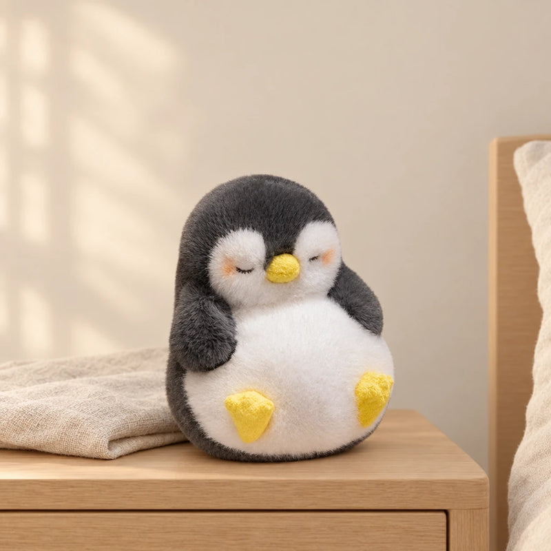 Peluche pingouin moelleux endormi