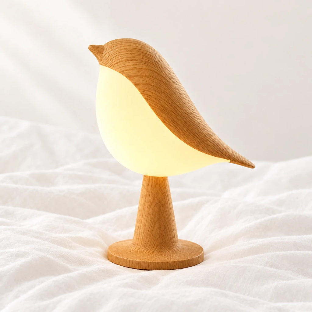Veilleuse oiseau tactile avec diffuseur en gros plan sur un drap blanc